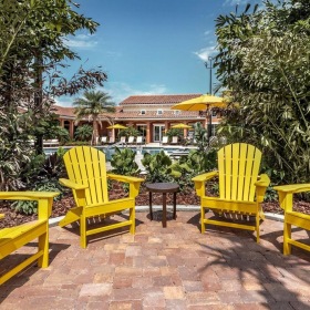 a group of yellow chairs on a patio