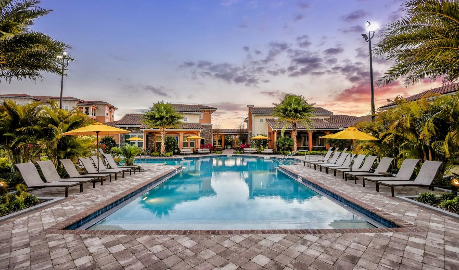 a pool with lounge chairs around it