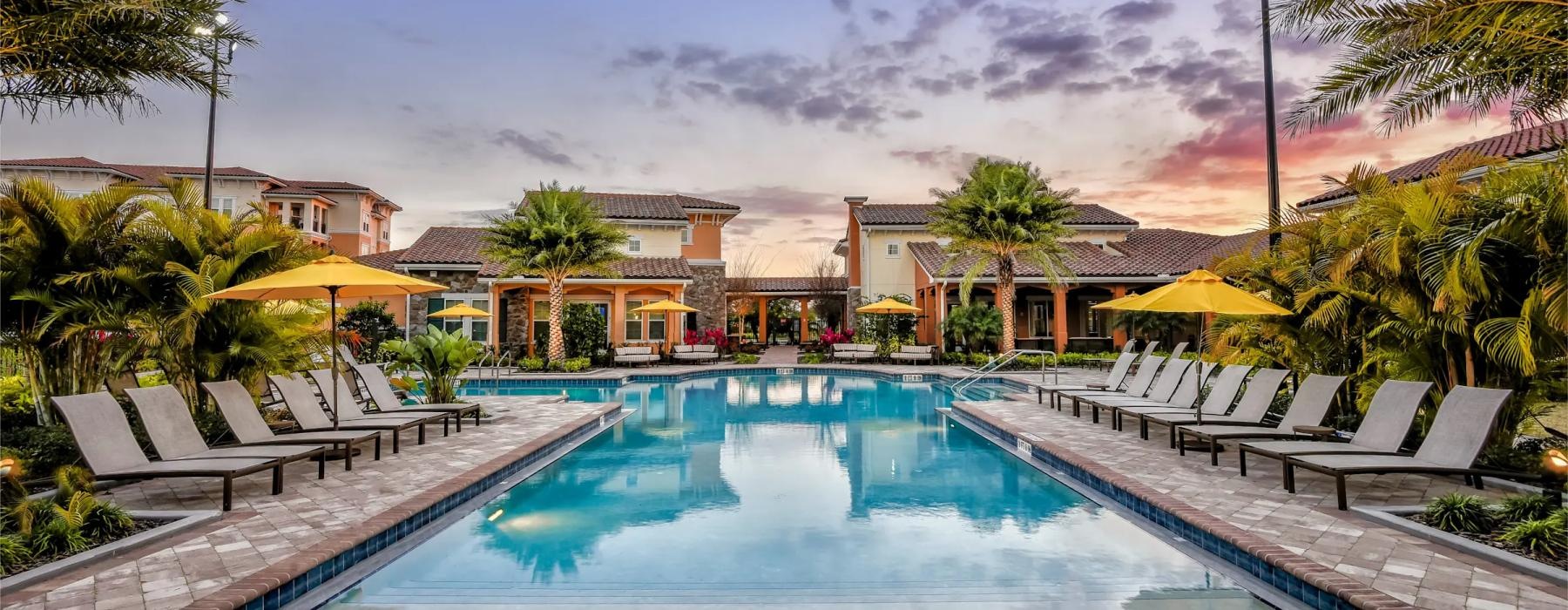 a pool with lounge chairs around it