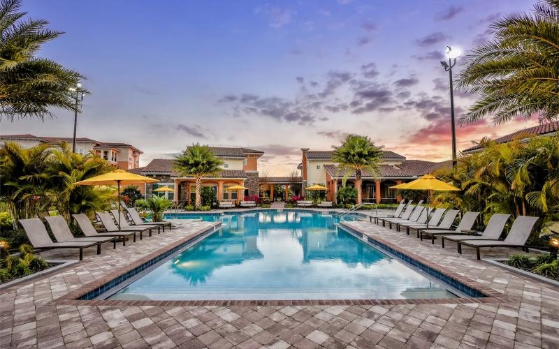 a pool with lounge chairs around it